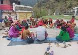 "BLOs conducting a meeting with villagers for voter awareness."