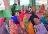 BLO explaining the voter list details to the village women.